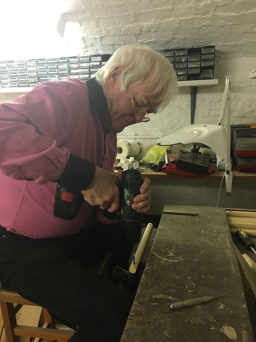 Photo of my father, Professor Iann Barron CBE, drilling holes into the dowels in his workshop.