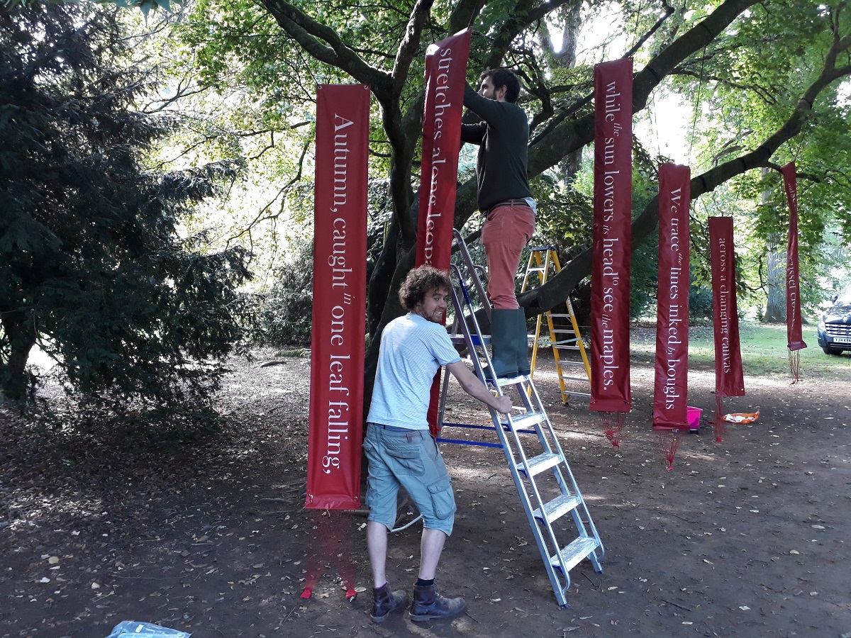 Luke and Chris hanging banners for September Slows